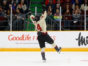 Ann-Sophie Bettez celebrates standing on one skate on the ice