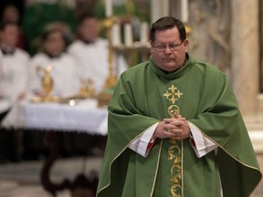 Quebec Cardinal Gérald Lacroix wears a green cloak with a gold pattern at a mass.