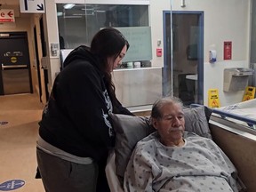 Matthew Mukash, 72, a former grand chief of the Grand Council of Crees in Quebec, has his bed lowered by his granddaughter Jade Mukash at a hospital in Montreal in a still image made from undated handout video footage.