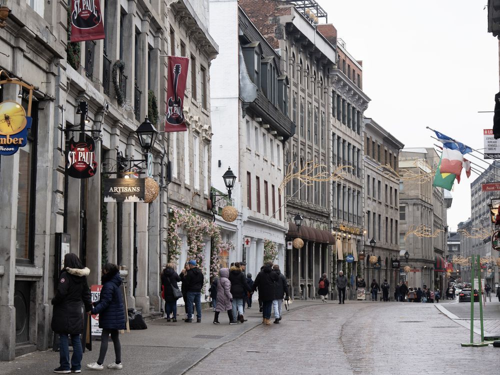 An unusually mild start to winter in Quebec is dampening spirits in a province otherwise known for its vibrant winter culture. People walk on the snowless streets in Old Montreal, Wednesday, Jan. 3, 2024.