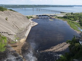 The bridge crossing the St. Lawrence River to the Island of Orleans is seen from the top of the Montmorency Falls on July 1, 2020, in Quebec City.