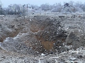 A crater of an explosion is seen next to the private building destroyed after a Russian missile attack in Novomoskovsk.