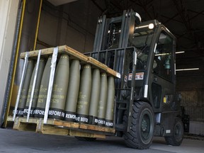 Airmen with the 436th Aerial Port Squadron use a forklift.