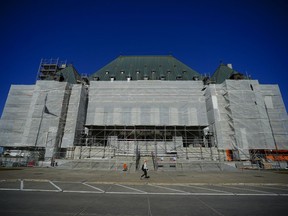 A person walks past the Supreme Court of Canada during construction in Ottawa on Monday, Oct. 23, 2023.