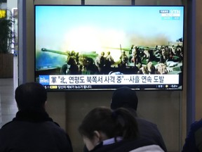 A TV screen shows a file image of North Korea's military exercise during a news program at the Seoul Railway Station in Seoul, South Korea, Sunday, Jan. 7, 2024.