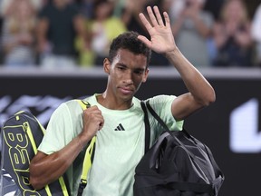 Félix Auger-Aliassime of Montreal waves as he leave the court following his third-round loss to Daniil Medvedev at the Australian Open on Saturday, Jan. 20, 2024.