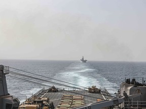 In this image provided by the U.S. Navy, the amphibious dock landing ship USS Carter Hall and amphibious assault ship USS Bataan transit the Bab al-Mandeb strait on Aug. 9, 2023.