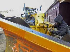 Kyle Whitworth, a highway equipment operator for the Brattleboro, Vt., Public Works Department, helps put a plow on a town grader on Friday, Jan. 5, 2024, in anticipation of this weekend's snow storm.