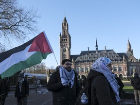 Protesters and media gather outside the Peace Palace, which houses the International Court of Justice, or World Court, in The Hague, Netherlands, Friday, Jan. 26, 2024.