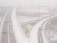 A highway interchange is seen in an aerial view during a snowstorm