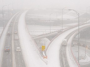 A highway interchange is seen in an aerial view during a snowstorm