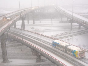 Aerial view of a city bus on an elevated, snow-covered highway