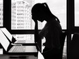 Woman sitting at computer screen.