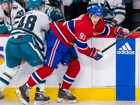 Canadiens' Sean Monahan steps around a check by San Jose Sharks' Tomas Hertl in Montreal on Jan. 11, 2024.