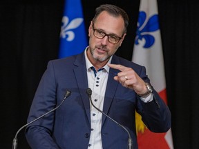 Jean-François Roberge gestures during a press conference.