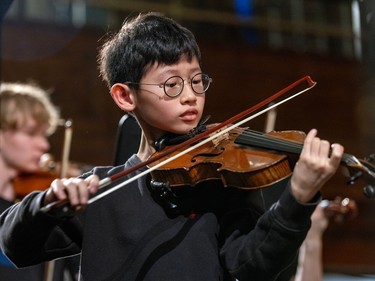 A boy plays violin.