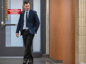 A man in a suit walks through a hallway at the Montreal courthouse.