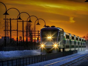 An Exo train moving along the track at sunset.