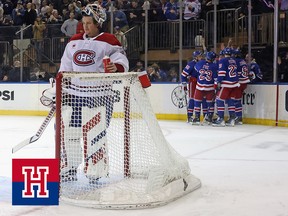 A Montreal Canadiens goalie stands dejected as New York Rangers celebrate in the background