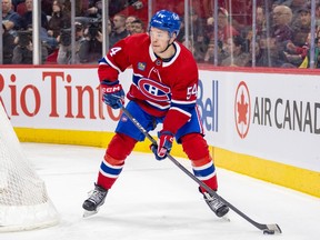 Canadiens defenceman Jordan Harris is seen near the boards in his own zone with the puck on his stick.