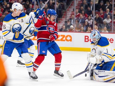 Canadiens' Brendan Gallagher and Sabres' Rasmus Dahlin in front of the Sabres goaltender