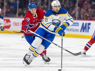Montreal Canadiens' Juraj Slafkovsky chases Buffalo Sabres' Alex Tuch on the ice