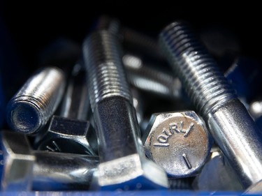 Closeup of loose machine bolts in a bin