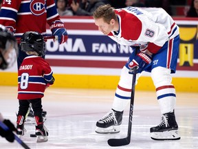 Canadiens defenceman Mike Matheson passes the puck with his son Hudson before the Canadiens' annual Skills Competition this past Sunday.