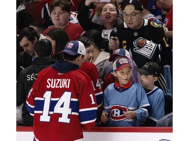 A young fan reacts after getting an autograph from Montreal Canadiens centre Nick Suzuki during the Canadiens' annual Skills Competition in Montreal on Sunday, Feb. 25, 2024.