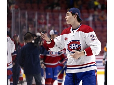 Canadiens' Juraj Slafkovsky tosses pucks to young fans after the Canadiens' annual Skills Competition in Montreal on Sunday, Feb. 25, 2024.