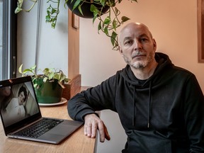 Montreal filmmaker Adrian Wills is seen with an image of his mother, Mary Margaret Cousins, from his film A Quiet Girl in Montreal on Feb. 22, 2024.