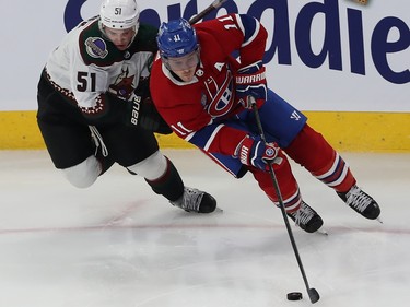 Montreal Canadiens' Brendan Gallagher skates with the puck with Arizona Coyotes' Troy Stecher behind him