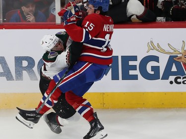 Montreal Canadiens' Alex Newhook (15) collides with Arizona Coyotes' Michael Kesselring