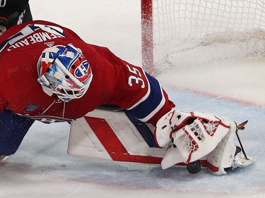 Montreal Canadiens goaltender Sam Montembeault drops a glove on the puck next to his pad