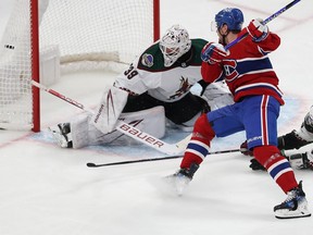 The puck is in the net behind Arizona's goaltender as Montreal Canadiens' Tanner Pearson follows through with his stick