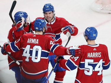 Canadiens players gather to celebrate a goal