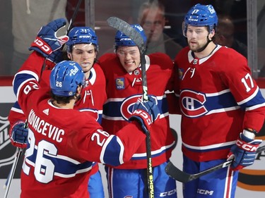 Canadiens players gather to celebrate a goal
