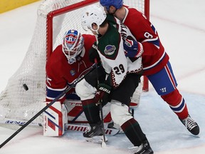 Arizona Coyotes' Barrett Hayton (29) gets in close on Montreal Canadiens goaltender Sam Montembeault and Mike Matheson (8) during second period NHL action in Montreal on Tuesday February 27, 2024.