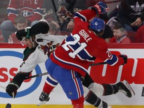 Montreal Canadiens' Kaiden Guhle collides with Arizona Coyotes' Alex Kerfoot along the boards