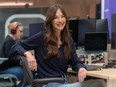 Video-game producer Jade Raymond smiles as she sits at her workstation.