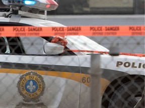 A Sûreté du Québec vehicle behind caution tape