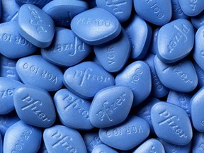 A bunch of blue Viagra pills are seen cloistered together.