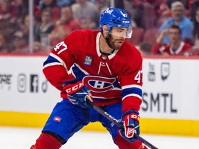 A hockey player is seen from the front in this photo, wearing a Habs jersey on the ice.