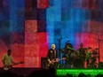 The Smashing Pumpkins perform on stage in front of a giant screen