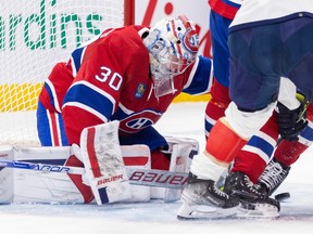 Canadiens goalie Cayden Primeau tracks the puck through players' legs during a game last November at the Bell Centre.
