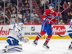 Canadiens' Juraj Slafkovsky jumps in front of Tampa Bay Lightning goalie Matt Tomkins in Montreal on Nov. 7, 2023.