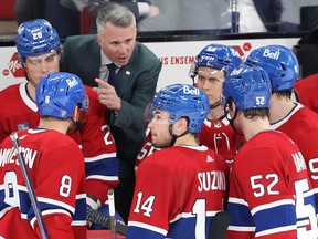 Canadiens head coach Martin St. Louis is seen with his foot resting on the Habs bench and his left index finger pointed as he animatedly talks to his players during a game at the Bell Centre.