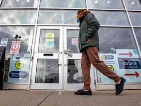 A woman walks by the COVID vaccination centre in Kirkland, west of Montreal Thursday December 1, 2022.
