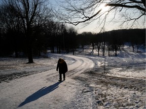 The setting sun of the winter solstice draws the shadow of the Montrealer walking along dirt path on Mount Royal on Friday December 20, 2019. Sunny skies, but the windchill will bite in the morning.