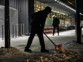 Hamsan Kennedy Vanniasingham cleared snow from in front of a grocery store that he works at on Somerled Avenue in the Notre-Dame-de-Grâce area of Montreal on December 20, 2020.